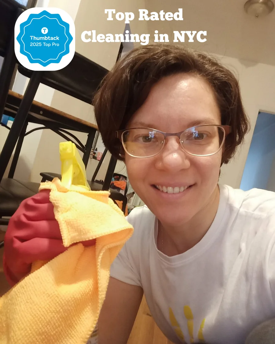Julia, founder of Brilliant Clean Home, smiling with cleaning supplies