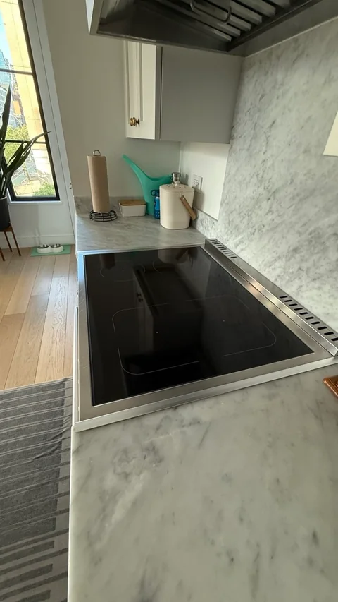 Polished cooktop and marble countertop